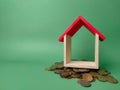 Wooden house on a scattering of coins Royalty Free Stock Photo