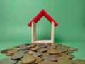 Wooden house on a scattering of coins Royalty Free Stock Photo
