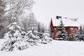 Wooden house in snow fairy forest, Christmas trees in the snow Royalty Free Stock Photo