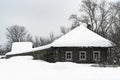 Wooden house in the snow, Russian village, winter, cloudy day.