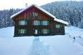 Wooden house in snowy landscape