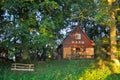 German wooden house in the sun in a green park or forest on a sunny day