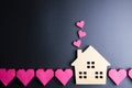 Wooden house toy and paper box red heart shape on black background with copy space.Real estate concept, New house concept, Love h Royalty Free Stock Photo