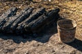 A wooden house in the village burned down because of a forest fire. Charred boards and various things lie on the ground, covered Royalty Free Stock Photo