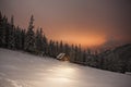 Wooden house in winter forest in Carpathian mountains Royalty Free Stock Photo