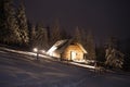 Wooden house in winter forest in Carpathian mountains Royalty Free Stock Photo