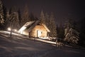 Wooden house in winter forest in Carpathian mountains Royalty Free Stock Photo