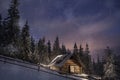 Wooden house in winter forest in Carpathian mountains Royalty Free Stock Photo