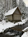 Wooden house in the winter forest. An old wooden building. A log house in the middle of a snowy forest Royalty Free Stock Photo