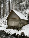 Wooden house in the winter forest. An old wooden building. A log house in the middle of a snowy forest Royalty Free Stock Photo