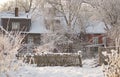 A wooden house with a wooden fence and frosted trees on a snowy, cold, sunny winter day, Kuldiga, Latvia Royalty Free Stock Photo