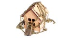 Chain lock wrapped around a wooden house model Royalty Free Stock Photo