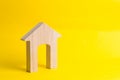 Wooden house on a yellow background. Concept of buying and selling housing, building a house. Rent of apartments. Realtors. Real e Royalty Free Stock Photo