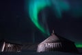 Wooden house, yurt hut on the background the polar Northern aurora borealis lights