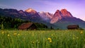 Wooden houses in the alpine ski town Garmisch-Partenkirchen captured against mountains at sunset Royalty Free Stock Photo