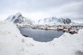 Wooden houses on the banks of the Norwegian fjord, beautiful mountain landscape in winter Royalty Free Stock Photo