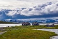 Wooden houses in dramatic landscape on cloudy summer day, Norway Royalty Free Stock Photo