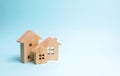 Wooden houses on a blue background. Wooden Toys. The concept of real estate and ownership, the purchase and sale of property. Royalty Free Stock Photo