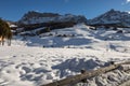 Wooden Houses, Mountains and Fresh Snow in Europe: Dolomites Alps Peaks in Winter Royalty Free Stock Photo