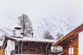 Wooden houses and mountains in snowfall Royalty Free Stock Photo