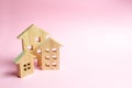 Wooden houses on a pink background. The concept of the city or town. Investing in real estate, buying a house. Management Royalty Free Stock Photo