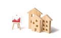 Wooden houses with a stand of graphics and information. Growing demand for housing and real estate. Statistics on the state Royalty Free Stock Photo