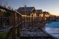 Wooden houses at sunset, village landscape at sunset