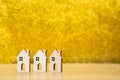 Wooden houses on a yellow background. Real estate and affordable housing concept. Mortgage, loan and insurance of apartments.