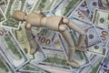 Wooden Human Figurine On The Dollar Cash Background