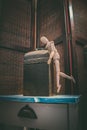 Wooden Human Manikin reaching into an antique metal canister Royalty Free Stock Photo