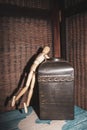 Wooden Human Manikin reaching into an antique metal canister Royalty Free Stock Photo