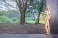 A Wooden Human Manikin standing relaxing watching a river outdoors, Fort Portal