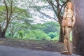 A Wooden Human Manikin standing relaxing watching a river outdoors, Fort Portal