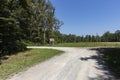 Wooden hunting post standing next to gravel path on the forest edge where wildlife go to graze the grass on the meadow behind near Royalty Free Stock Photo