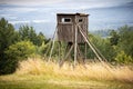 Wooden hunting tower with field on foreground Royalty Free Stock Photo
