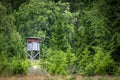 Wooden hunting tower in a green forest