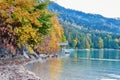 Wooden hut with boats on the lake in the autumn forest in the morning in the Alps Royalty Free Stock Photo