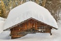 Wooden hut covered by snow in Alps Royalty Free Stock Photo