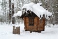 Wooden hut covered with snow in the winter forest. Hut on chicken legs. Baba Yaga house. Deer Streams nature park. Ural, Russia Royalty Free Stock Photo
