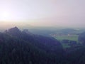 Wooden hut for hiker on the sharp peak of forest hill. Autumn mist bellow in valley. Royalty Free Stock Photo