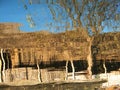 Wooden hut reflected in the waters of Inle Lake