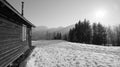 Wooden hut with shutters and narrow chimney in the snow in black and white Royalty Free Stock Photo