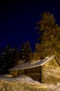 Wooden hut in snowy finnish winter night Royalty Free Stock Photo