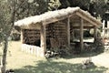 Wooden hut with wooden chairs under the straw roof in the countryside Madeira, Portugal Royalty Free Stock Photo