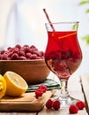 On wooden is ice cold beverage glass with raspberry cocktail . Royalty Free Stock Photo