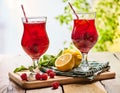 On wooden are ice cold beverage glasses with berries cocktail . Royalty Free Stock Photo