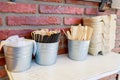 Wooden ice cream sticks and cocktail tubes are in small iron buckets Royalty Free Stock Photo