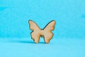 Wooden icon of butterfly on blue background Royalty Free Stock Photo