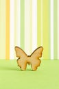 Wooden icon of butterfly on green striped background Royalty Free Stock Photo