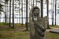 Wooden idol of woman in forest